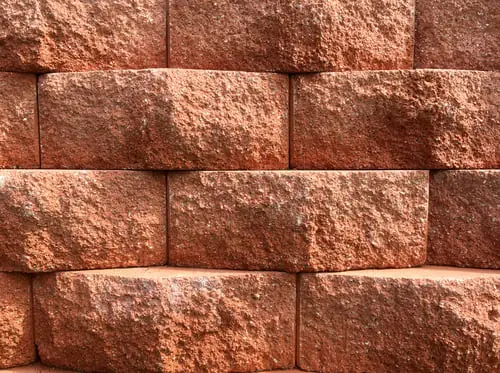 Why Retaining Walls Fail in Carolina Clay (It Is Almost Never the Stone)